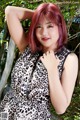 A woman in a leopard print dress posing for a picture.